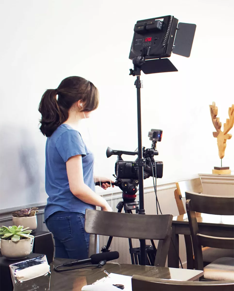 Digital Production Student with camera and lighting