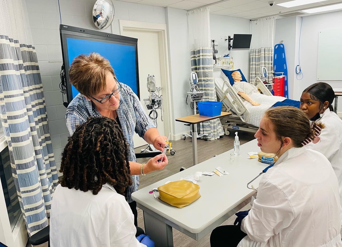 Nursing Students with Faculty in sim lab
