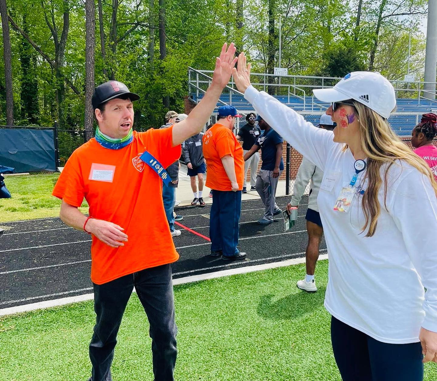 Nursing Student high-fiving athlete at Special Olympics